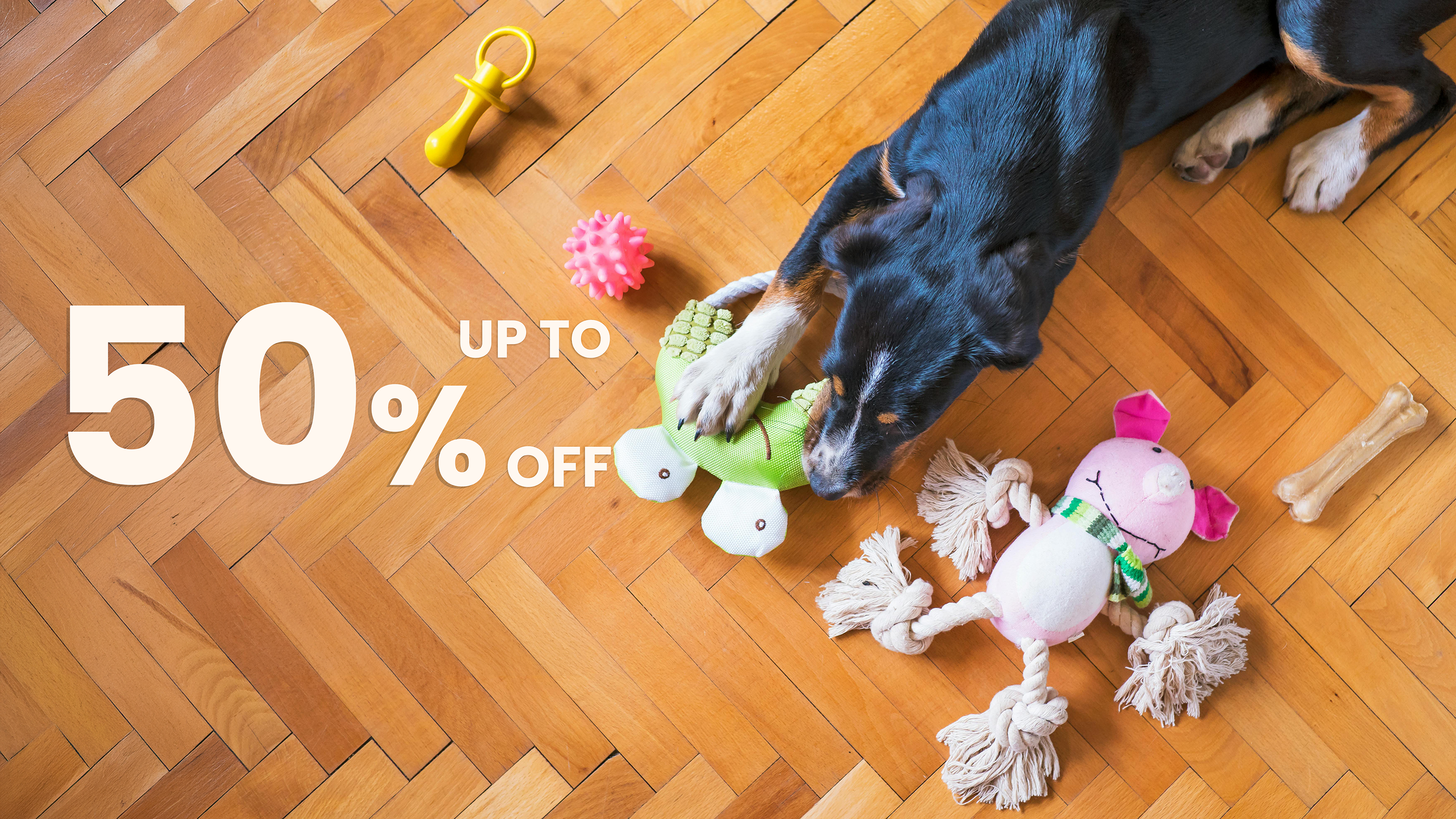 Dog playing with toys on a wooden floor with promotional text overlay.