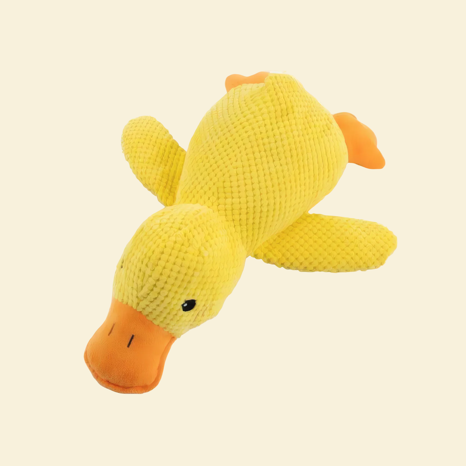 Yellow plush duck toy on a yellow background