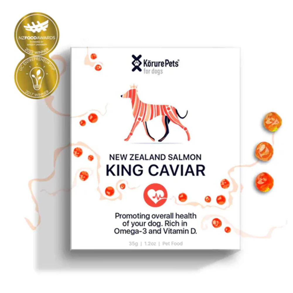 Front box of Kōrure Pets New Zealand King Salmon Caviar next to scattered orange caviar pearls, featuring NZ Food Awards and UC Entrepreneurship winner badges.