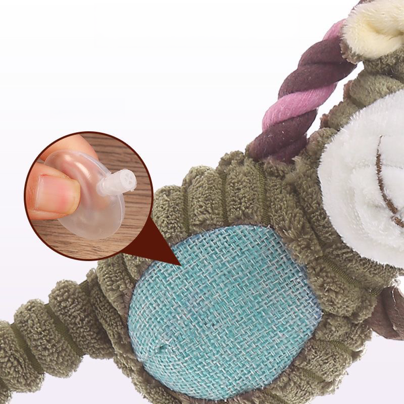 Cutaway view of the corduroy dog toy revealing the hidden internal squeaker mechanism inside the belly, designed to trigger natural play instincts.