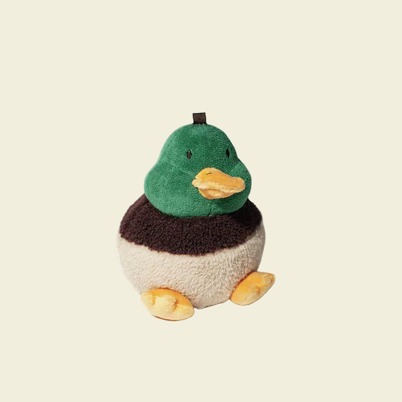 A close-up view of the adorable PAWZCITY soft plush duck poop bag holder, featuring a green head, brown neck, cream body, and orange feet.