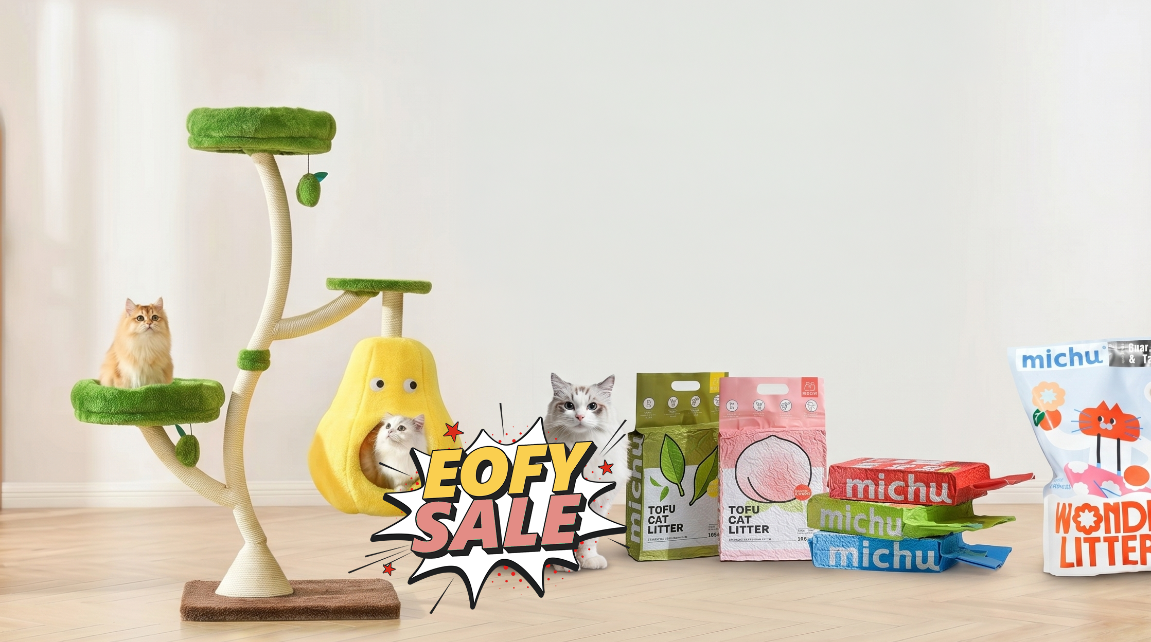Cat tree, litter products, and cats on a wooden floor with a white wall background