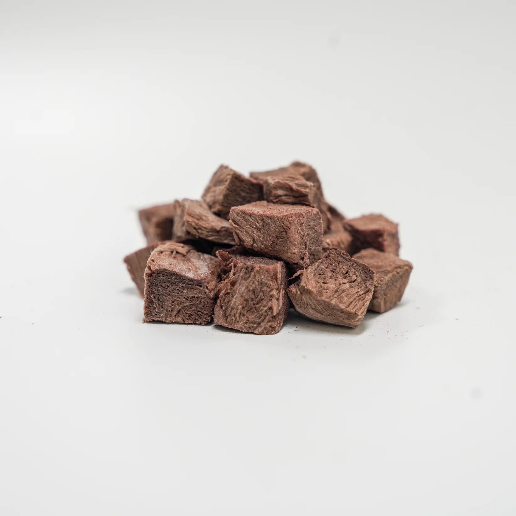 A close-up pile of Rafa Raw freeze-dried kangaroo steak cubes. Dark, rich, single-ingredient raw meat pieces perfect for high-value training rewards and pets with sensitive stomachs.