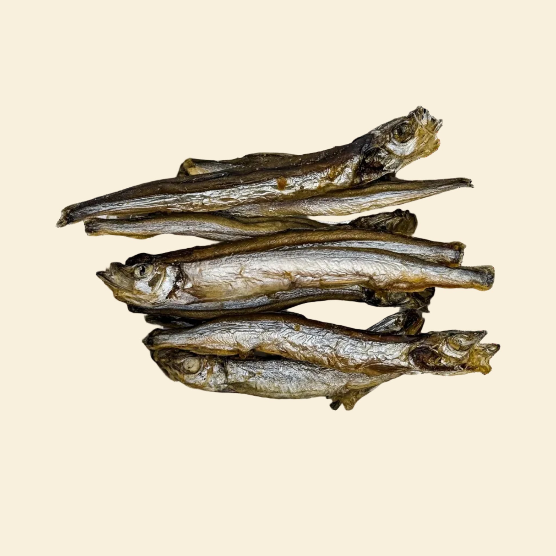 A top-down view of several freeze-dried whole capelin fish. High-protein, crunchy seafood treats for dogs and cats with 60% crude protein.