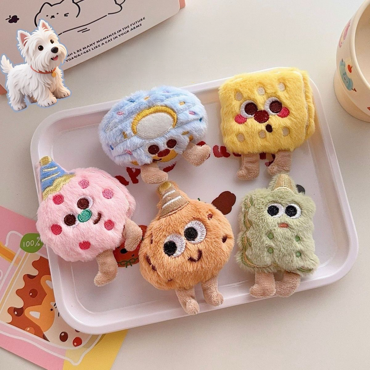 A delightful collection of five kawaii plush bakery squeaky toys with a white dog, including cookies and biscuits with embroidered faces, beautifully displayed on a checkered picnic cloth.