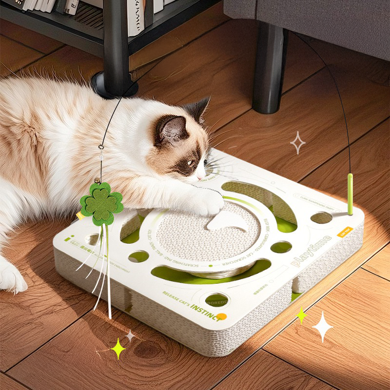 A Ragdoll cat interacting with the white Busy Box on a wooden floor. The low-profile design fits perfectly in any modern home to reduce separation anxiety
