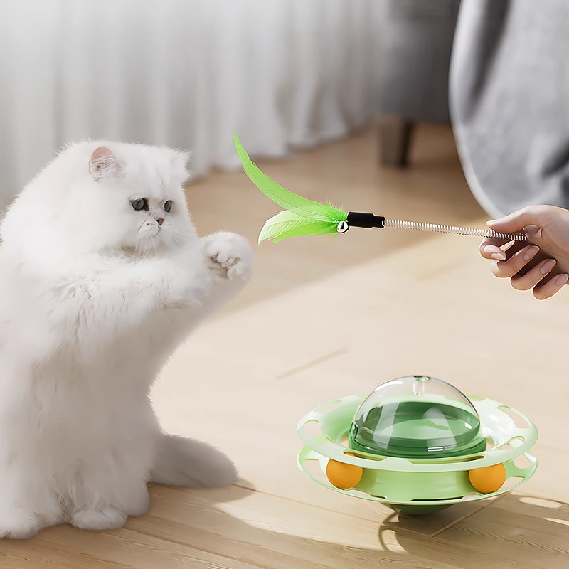 Owner playing with a white cat using the detachable feather wand from the enrichment toy. Promotes 2-way bonding and exercise.