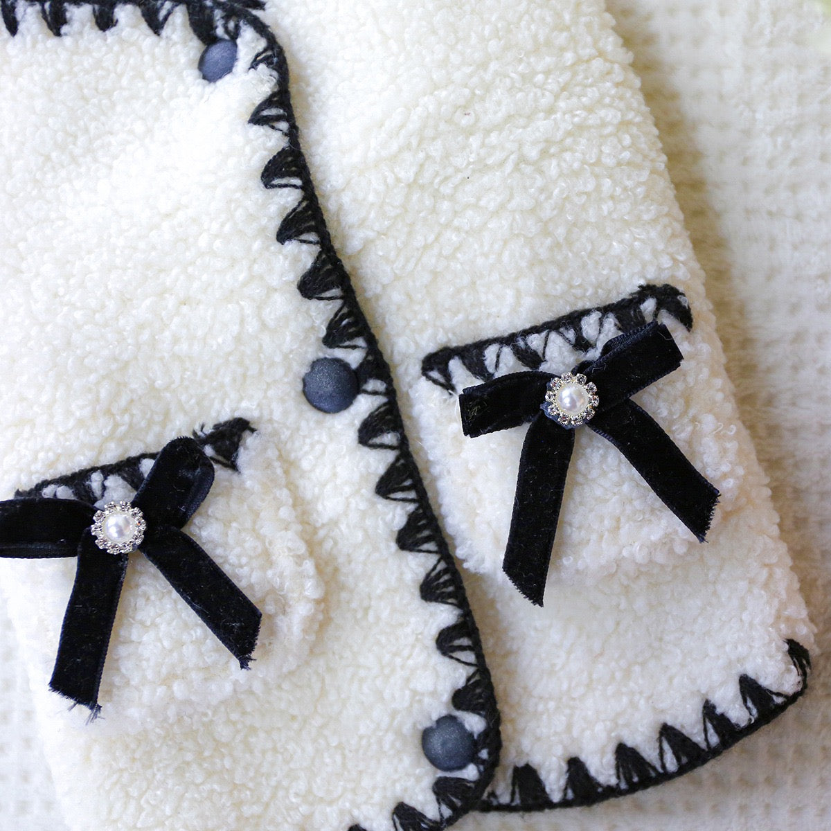 Close-up of the plush velvet bows with sparkling pearl centers. These chic accents turn any sidewalk into a runway for your fashionable pet