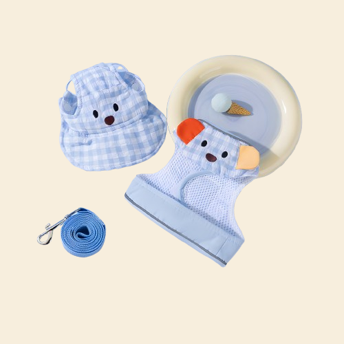 Isolated view of the Blue Gingham Dog Travel Set components. Features an integrated harness jacket and sun hat for a sophisticated, coordinated look