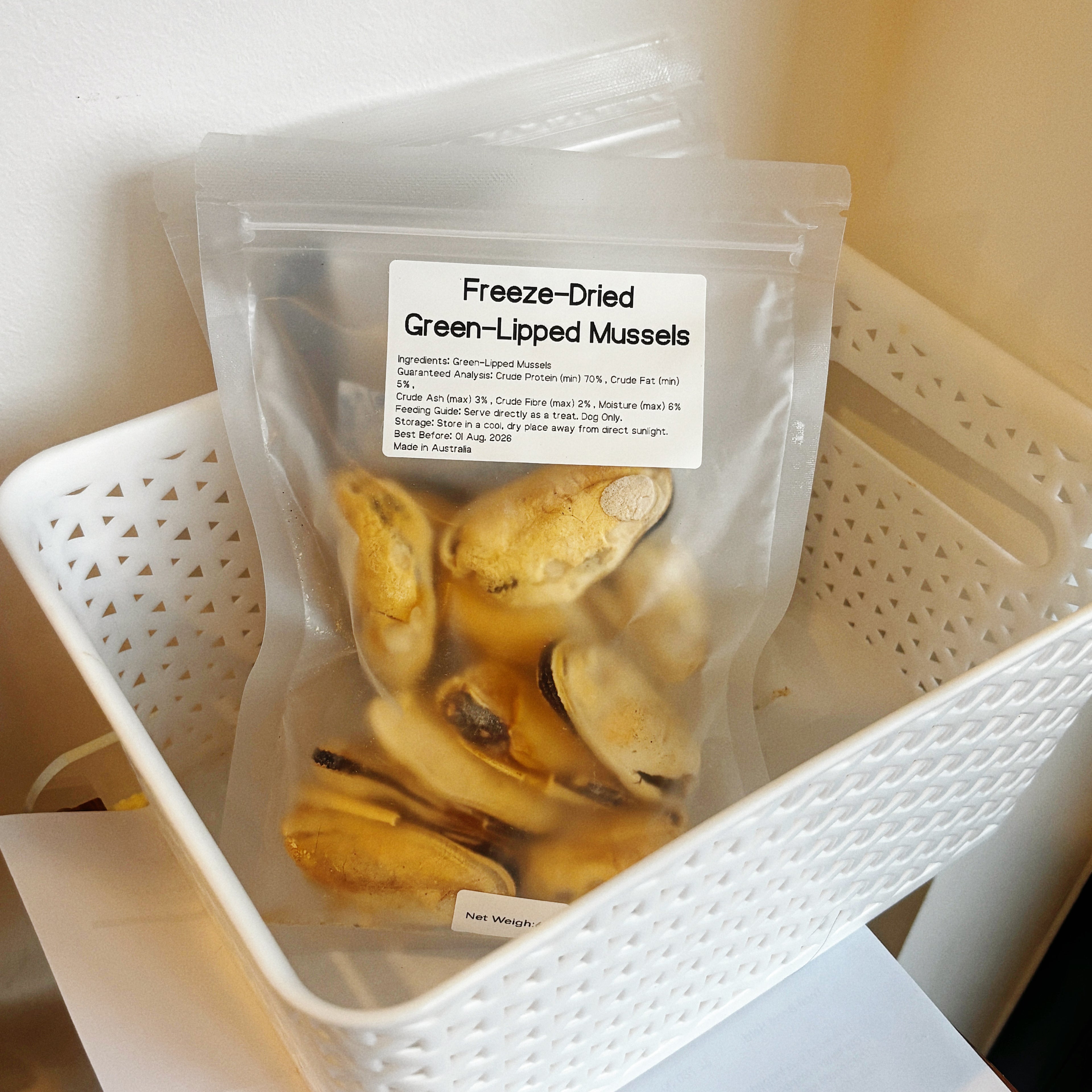 Multiple bags of green-lipped mussels in a basket, a potent natural anti-inflammatory superfood for senior dogs and active breeds.