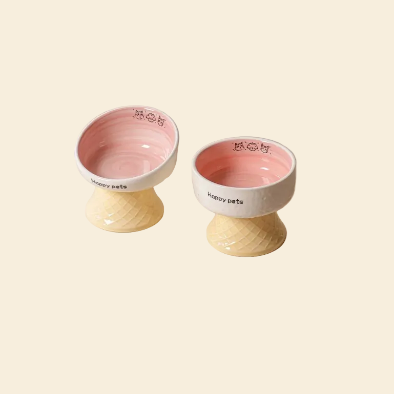 Happy Pets Ceramic Dining Set in Pink. Features one elevated tilted food bowl for neck protection and one elevated flat water dish for easy sipping