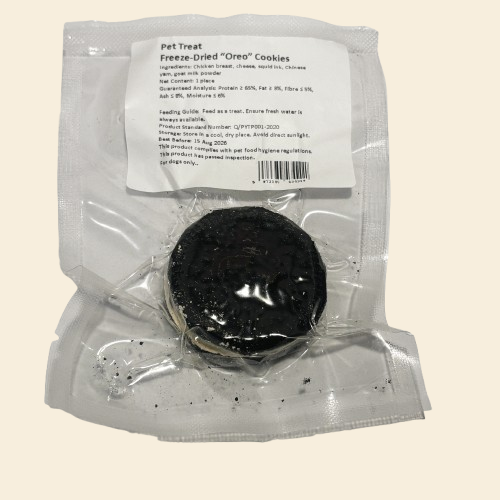 A single freeze-dried "Oreo" style dog cookie, made with squid ink chicken wafers and a creamy goat milk and cheese filling.