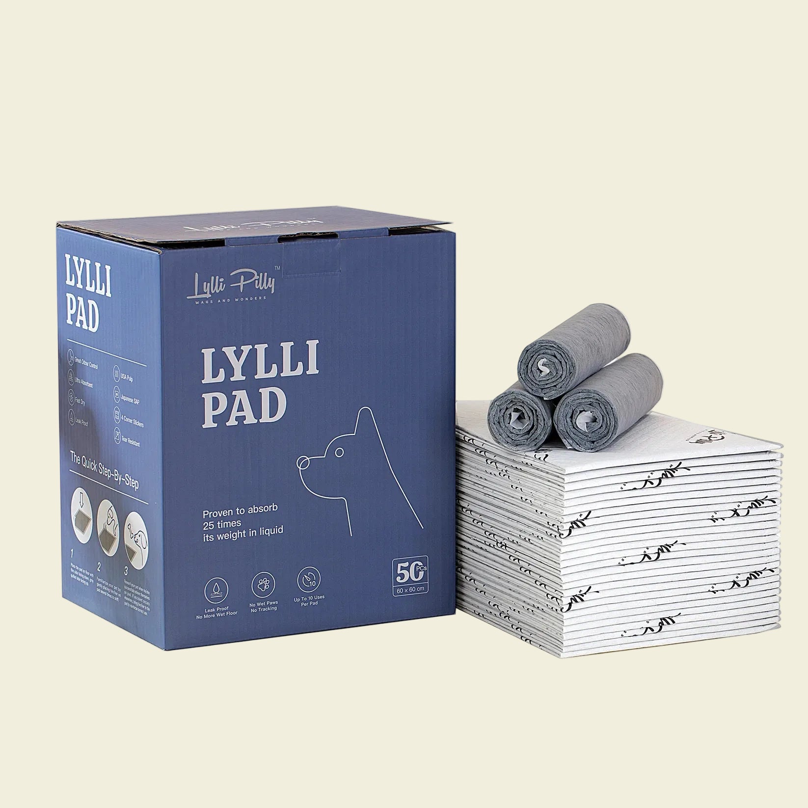 A 50-pack blue box of 60x60cm LYLLI PILLY pet pads displayed next to a neat stack of folded and rolled-up grey training pads.