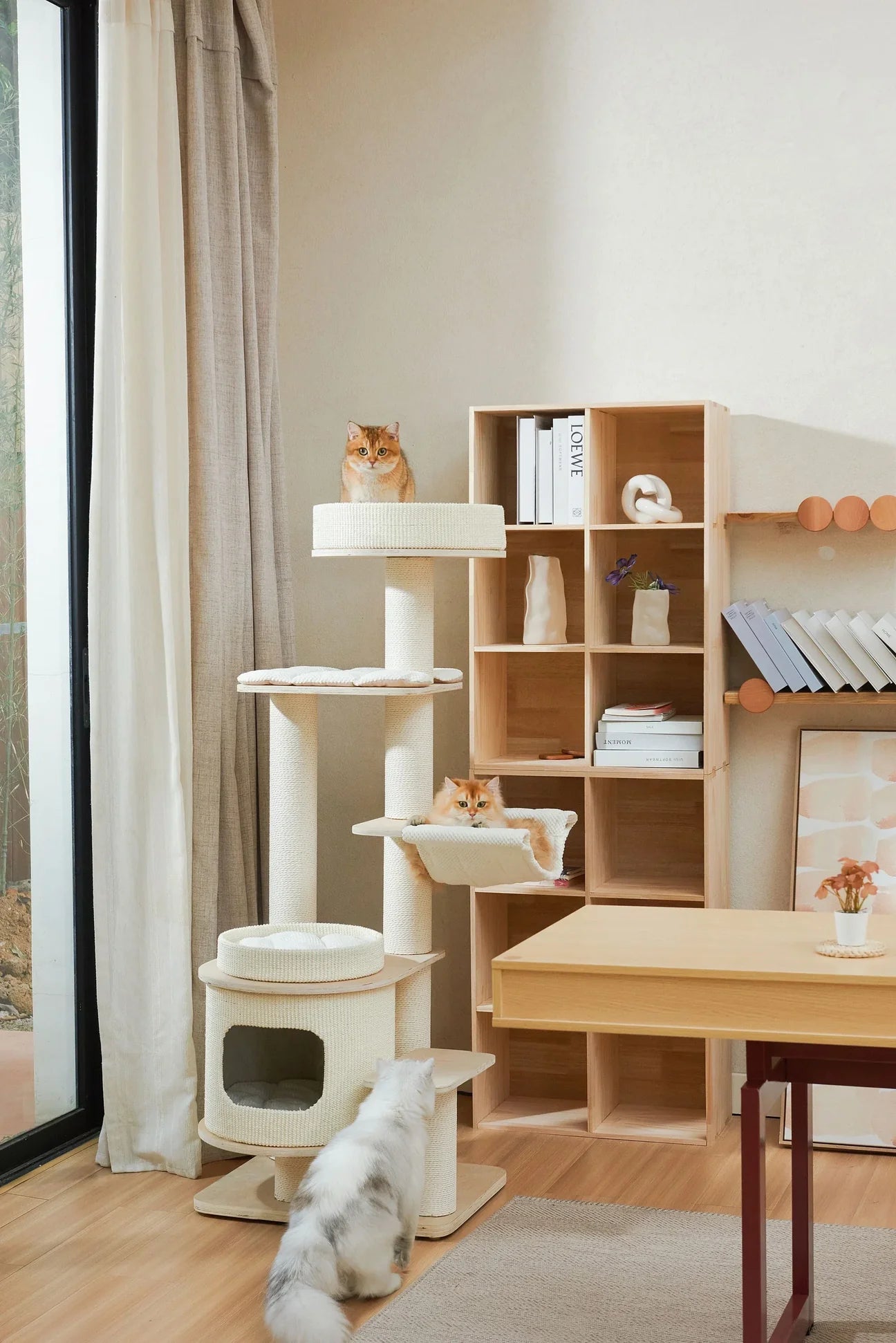 Michu Luna Solid Wood Cat Tree placed in a modern minimalist living room. A multi-level aesthetic cat tower featuring natural wood and cream accents, blending seamlessly with stylish home decor.