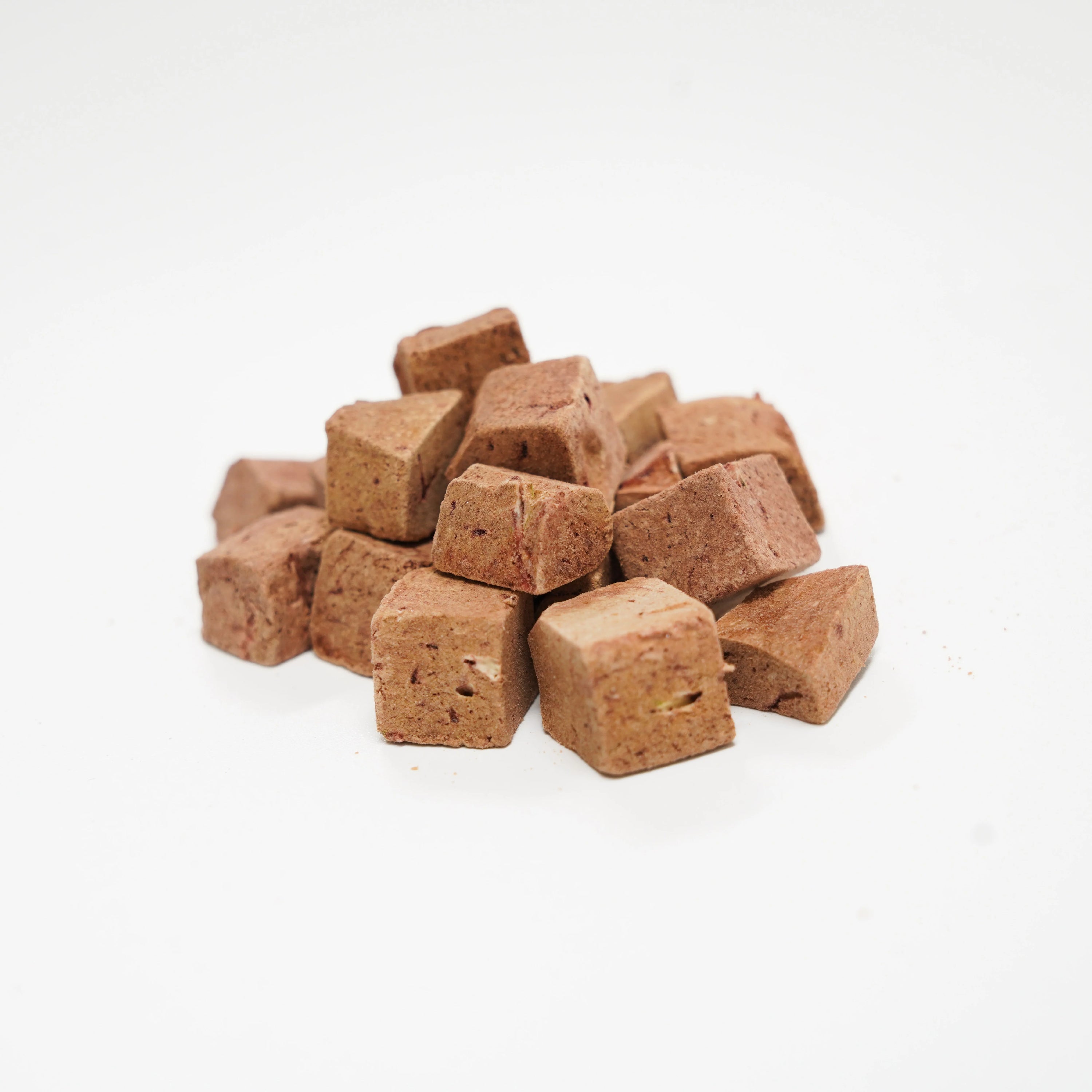 A close-up pile of Rafa Raw freeze-dried emu liver cubes. A single-ingredient, human-grade superfood treat for dogs and cats that can easily be broken into smaller pieces for training.