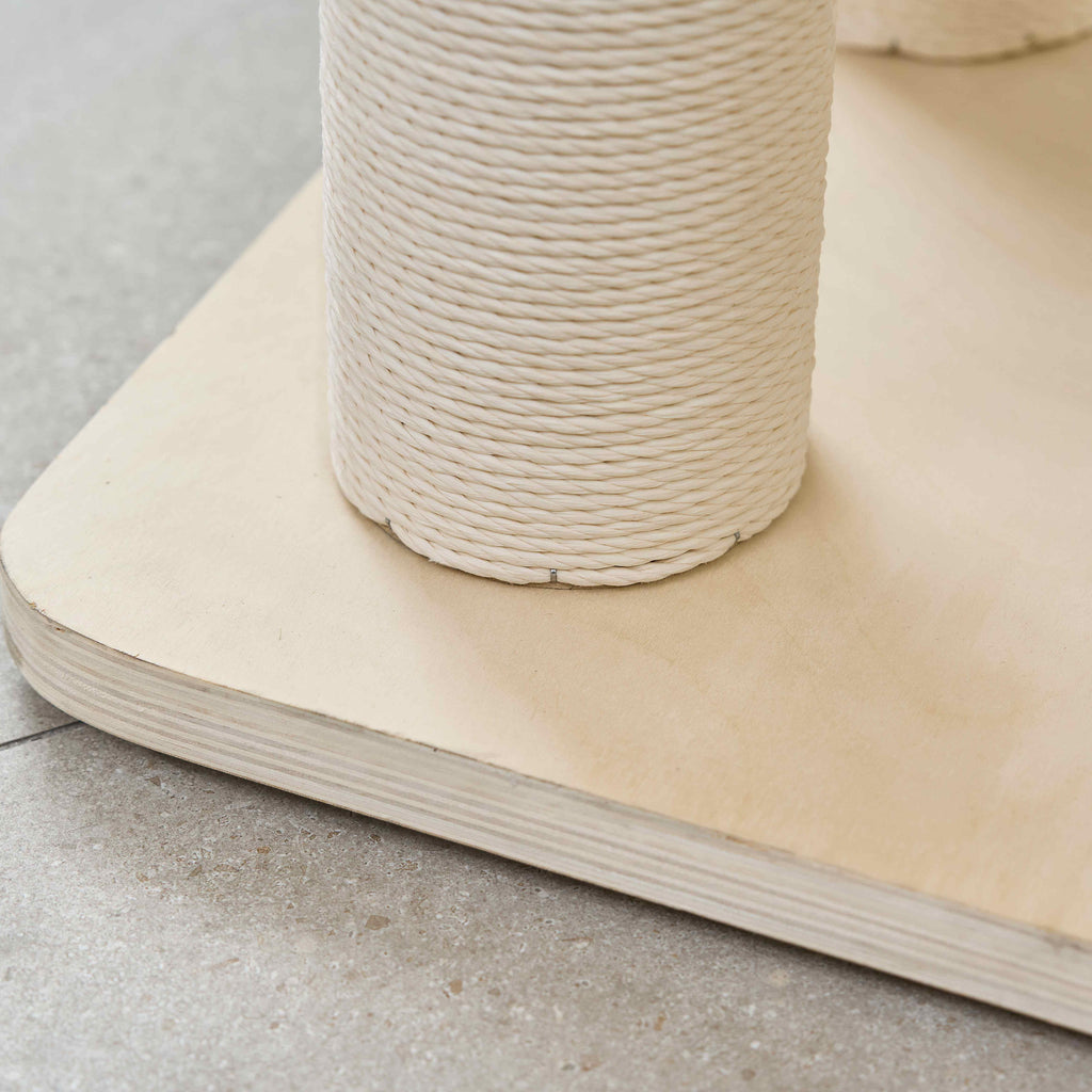 Close-up detail of the heavy flat wooden base board and durable wrapped sisal scratching post