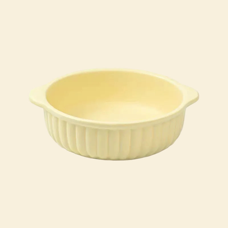 Full product view of the pastel yellow Mango Dual-Ear Ceramic Pet Bowl on a white background, highlighting its stable wide base and convenient side handles.