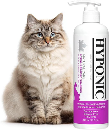 A fluffy long-haired cat sitting next to a bottle of HYPONIC Hypoallergenic Cat Shampoo.