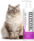 A fluffy long-haired cat sitting next to a bottle of HYPONIC Hypoallergenic Cat Shampoo.