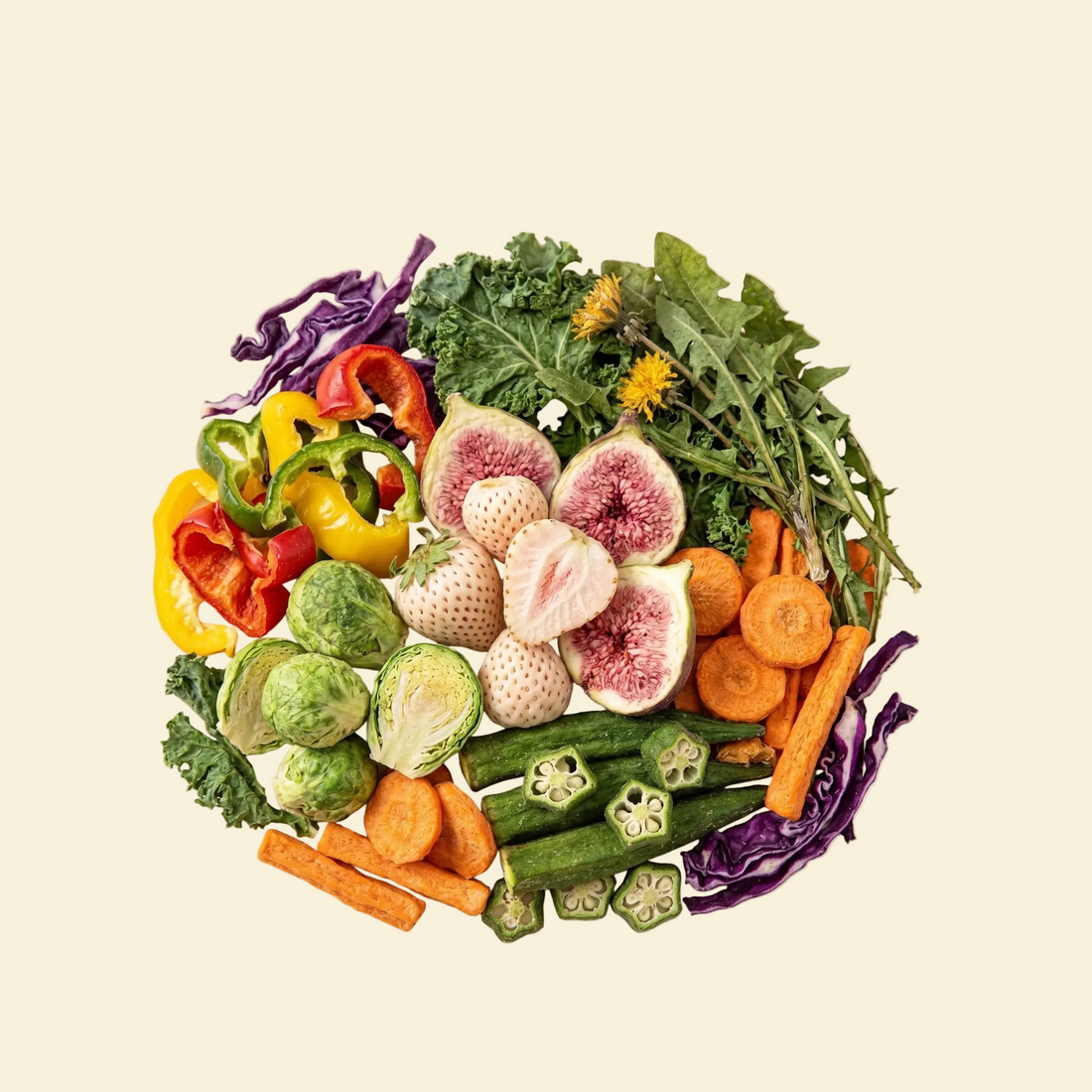 Assorted fresh vegetables including bell peppers, figs, carrots, and okra on a white background