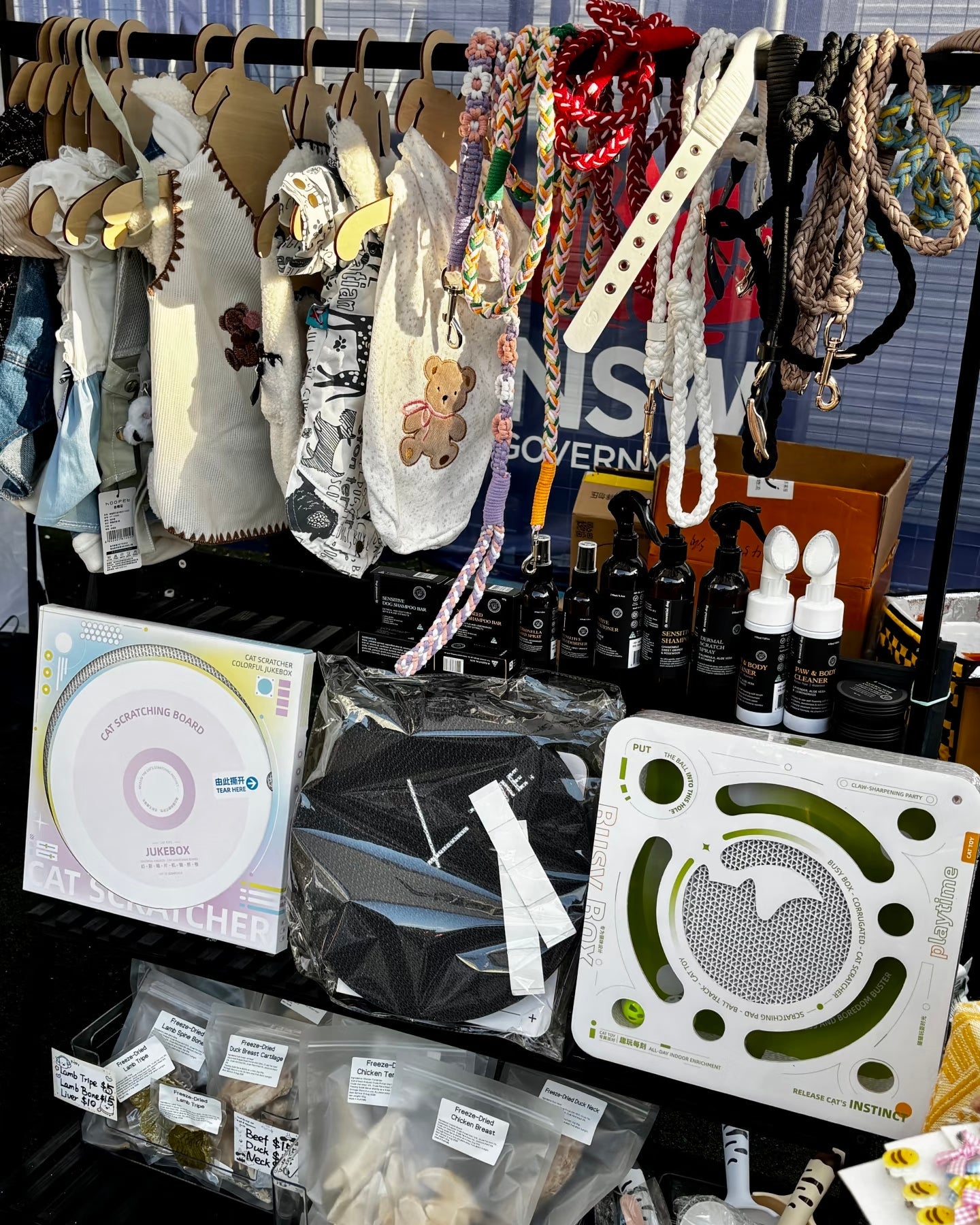 Display of various items including necklaces, toys and other small clothes on a rack.