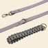 Purple leather strap with gold hardware and a gray braided handle on a white background