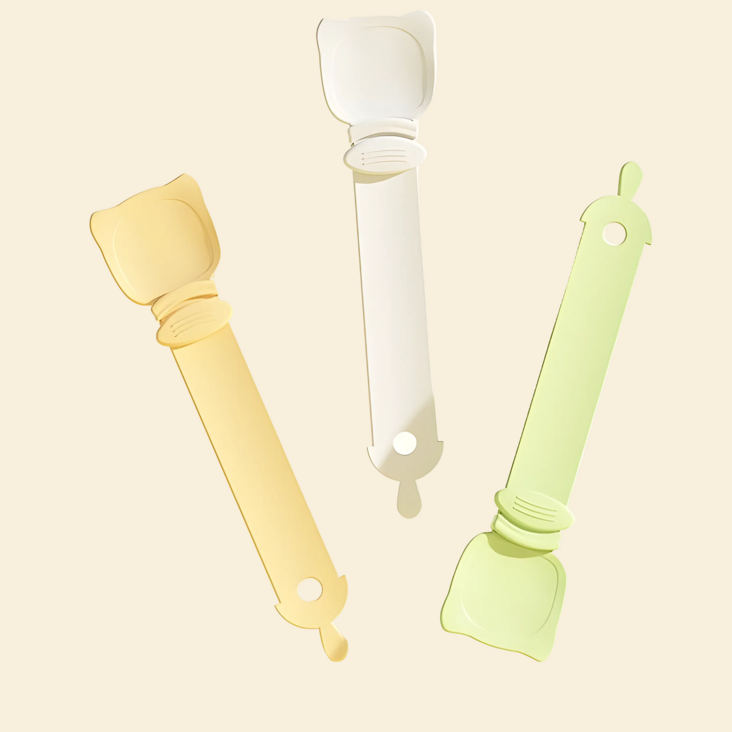 Three cat liquid treat feeding spoons dynamically floating in Soft Green, Cream Beige, and Pastel Orange. Aesthetic and minimalist pet accessories for modern homes.