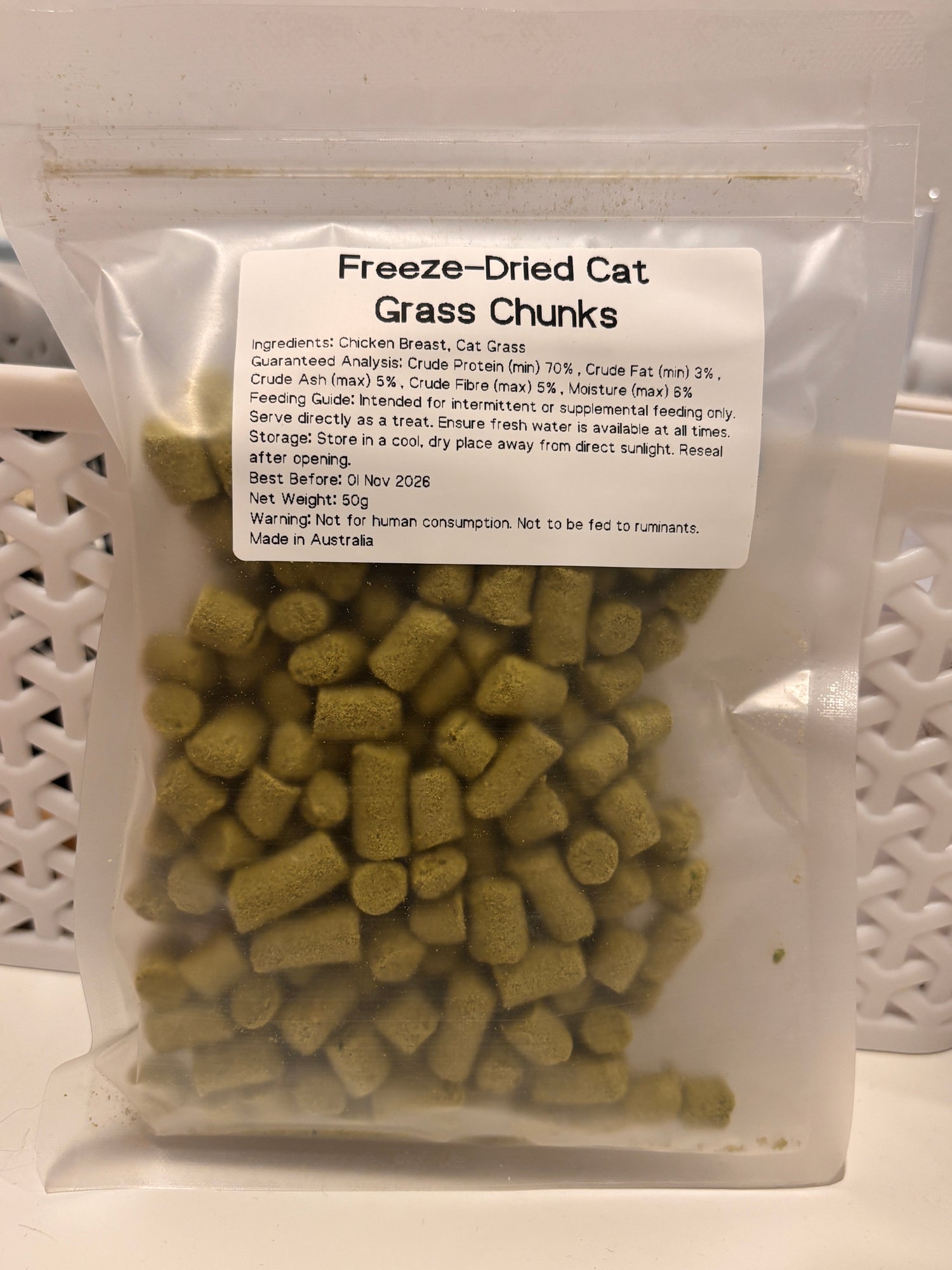 The 50g packaging of Freeze-Dried Cat Grass Chunks, featuring a detailed label that lists the pure chicken breast and cat grass ingredients, guaranteed analysis, and proudly states "Made in Australia."