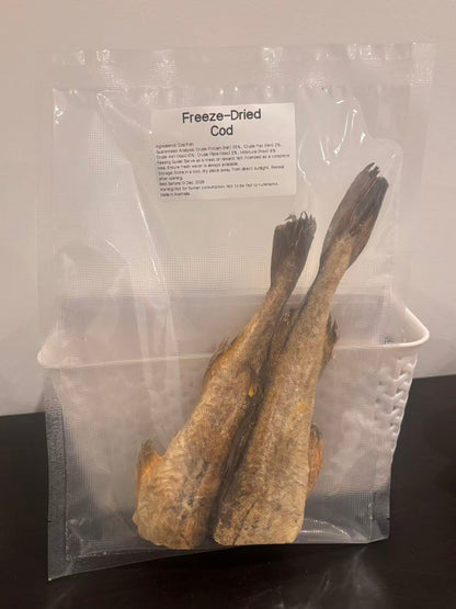 A real-world photo of Freeze-Dried Cod pet treats in a clear vacuum-sealed bag. The label clearly displays the single-ingredient purity, guaranteed analysis highlighting the ultra-low 2% fat, and proudly states "Made in Australia."