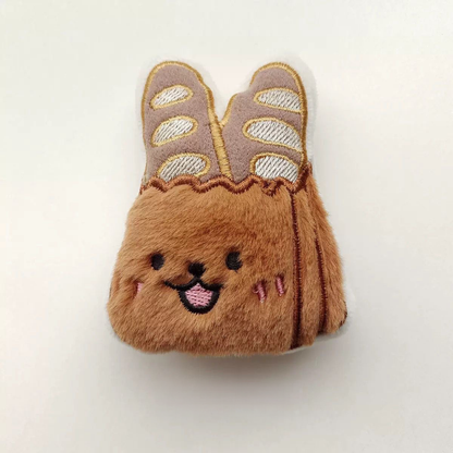 A cute 9cm baguette loaf plush toy with a toasted brown gradient and a built-in squeaker for interactive fun.
