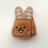 A cute 9cm baguette loaf plush toy with a toasted brown gradient and a built-in squeaker for interactive fun.