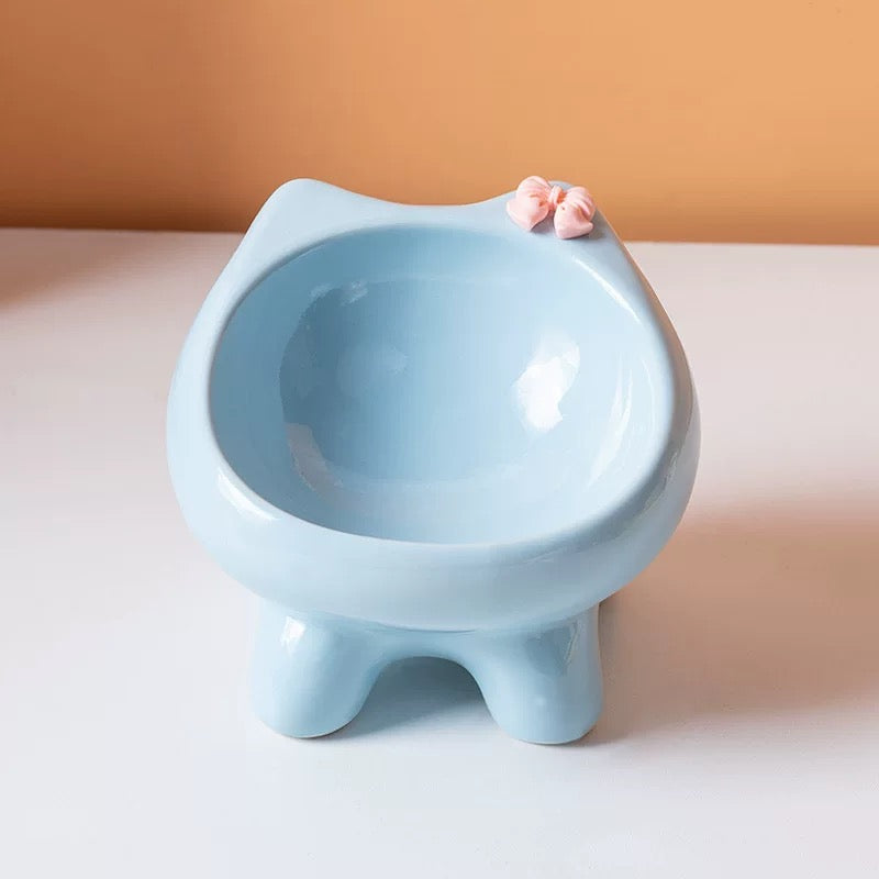 A front view of the light blue cat-ear ceramic pet bowl, showcasing its elevated ergonomic design and anti-spill curved interior.