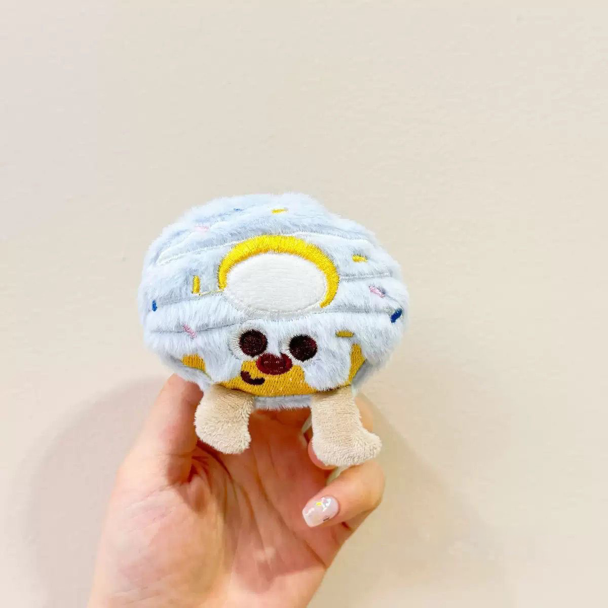 A bite-sized blue frosted cookie plush squeaky toy complete with a festive party hat, making it the perfect prop for pet birthdays.