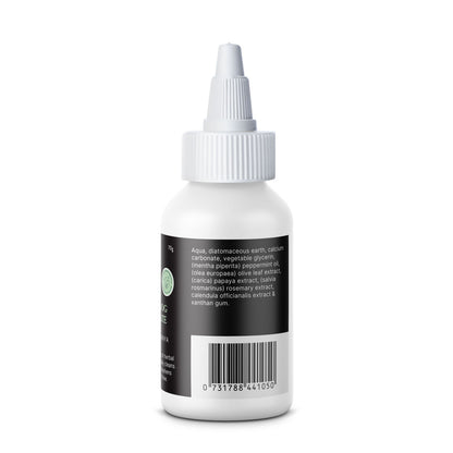 Side view of the Essential Dog Herbal Dog Toothpaste bottle, listing the natural ingredients such as diatomaceous earth, calcium carbonate, peppermint oil, papaya extract, and rosemary extract.