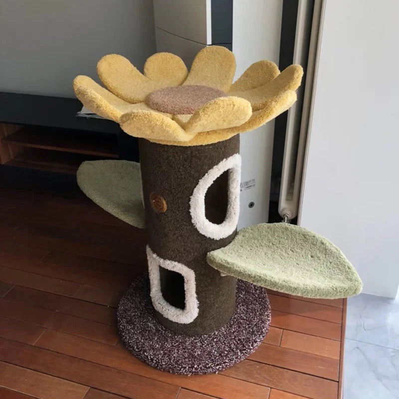 Cat tree designed like a sunflower with a cylindrical base on a wooden floor.