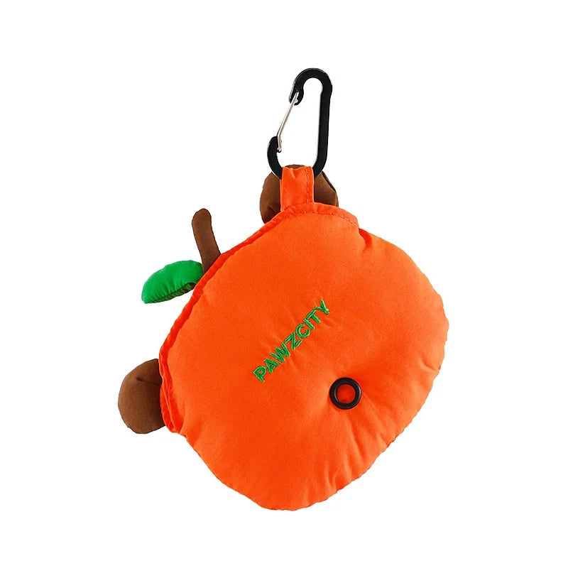 Back view of the PAWZCITY Capybara waste bag dispenser hanging from a sturdy black carabiner clip, showing the embroidered logo and the rubber dispensing hole for easy access to pet poop bags.