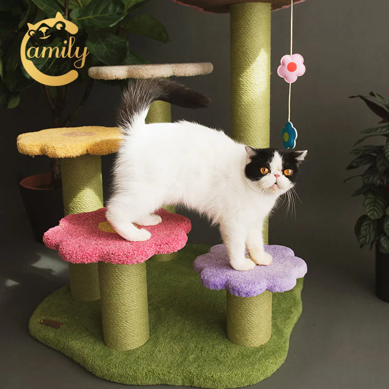 A black and white cat easily stepping across the gradient pink and purple flower platforms of the Camily climbing tree, highlighting the safe and naturally accessible blooming stairway design.