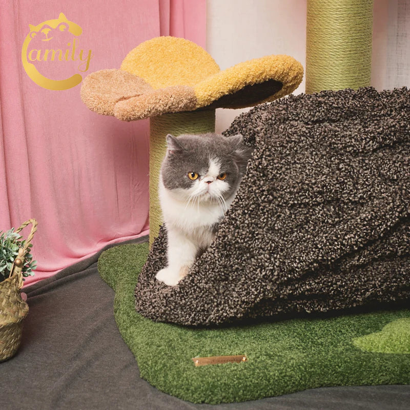 A close-up of a grey and white cat exploring the beautifully textured, spacious tree log tunnel of the Camily cat tree, showcasing the secure hideaway and scratch-resistant nylon fiber velvet material.