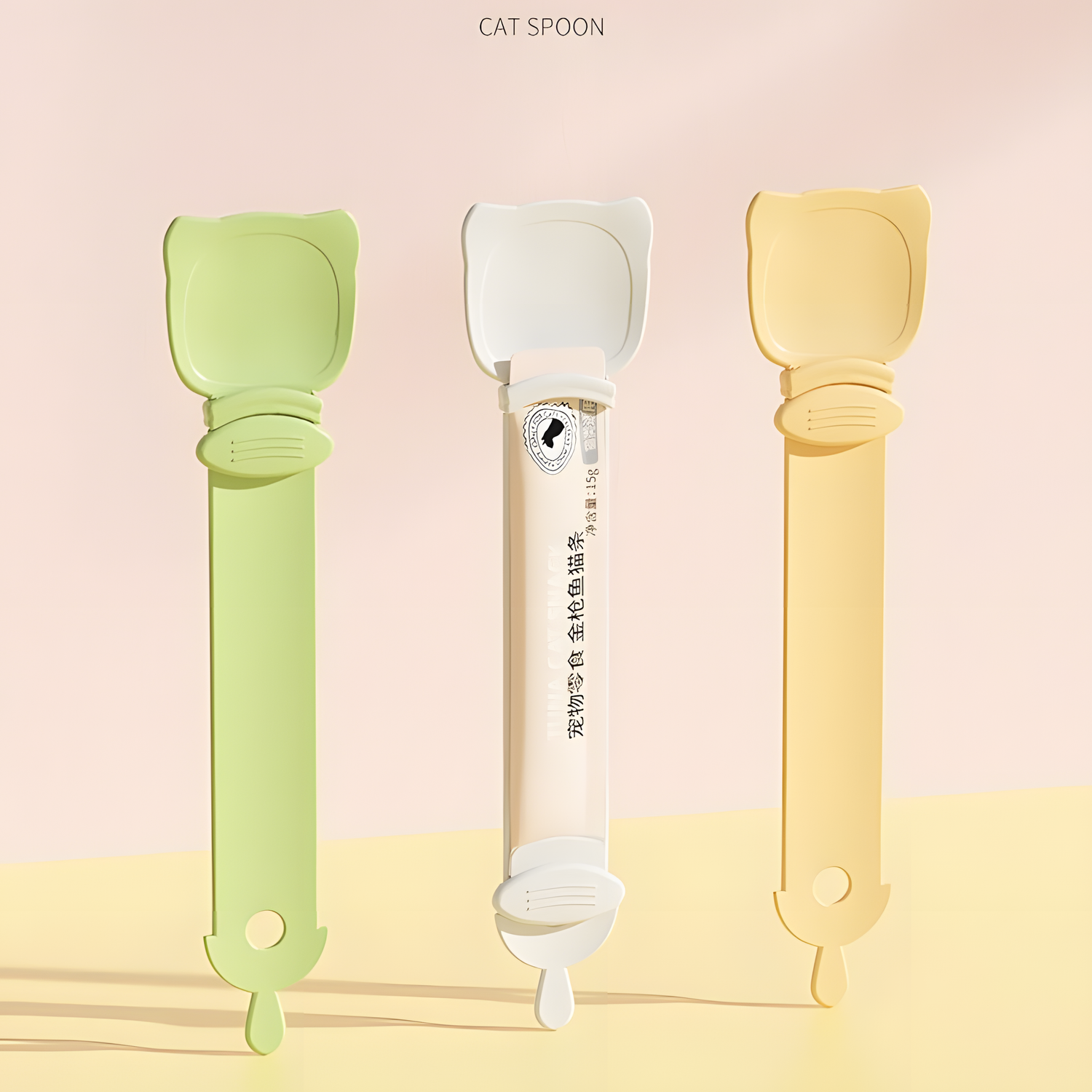 Three Cat Liquid Treat Feeding Spoons in pastel green, cream beige, and orange. The middle spoon securely holds a standard liquid cat treat tube, demonstrating its universal fit.