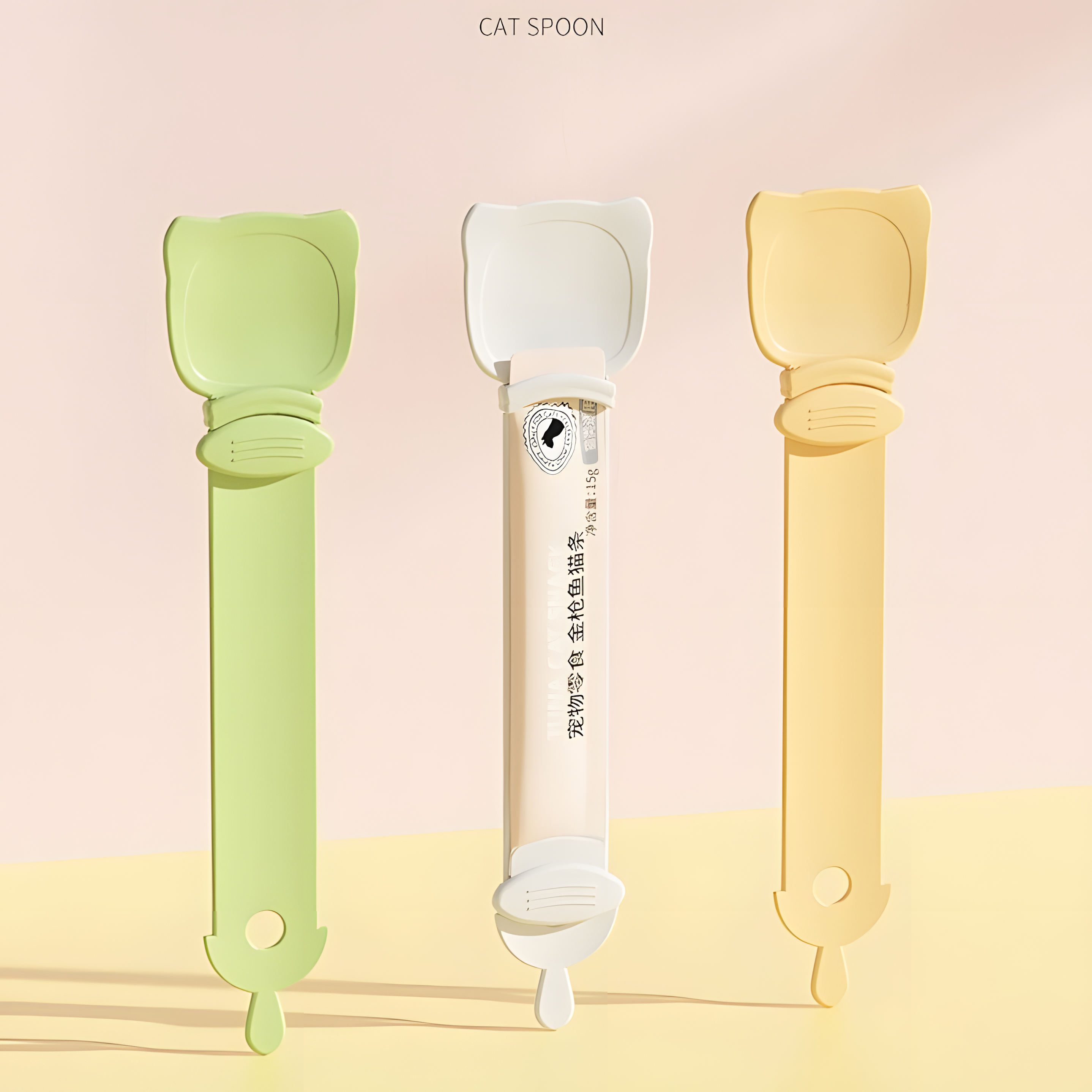 Three Cat Liquid Treat Feeding Spoons in pastel green, cream beige, and orange. The middle spoon securely holds a standard liquid cat treat tube, demonstrating its universal fit.
