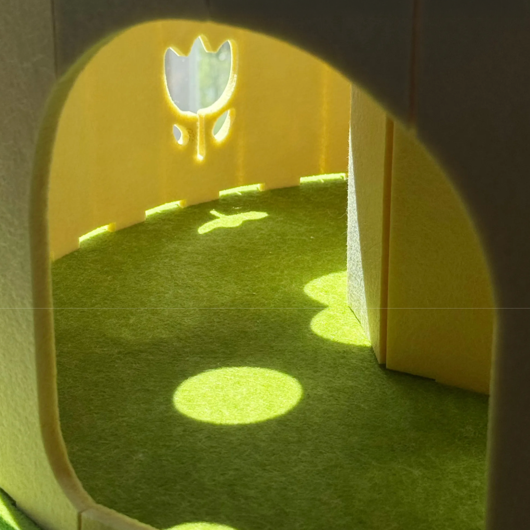 cats playpen with green grass-like surface and yellow archway