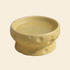 Yellow ceramic bowl with cheese surface