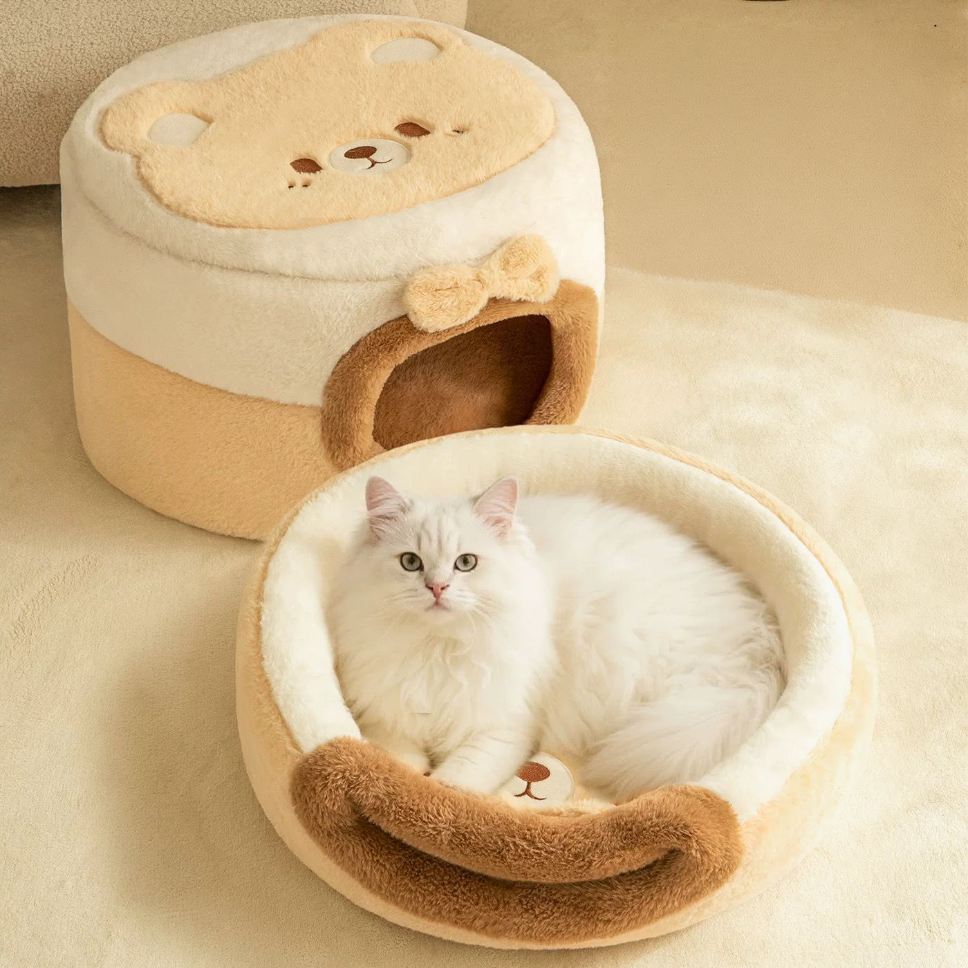 A white cat lying in the open nest configuration of the 2-in-1 plush cat bed, with the enclosed cave version displayed in the background to show the versatile design.