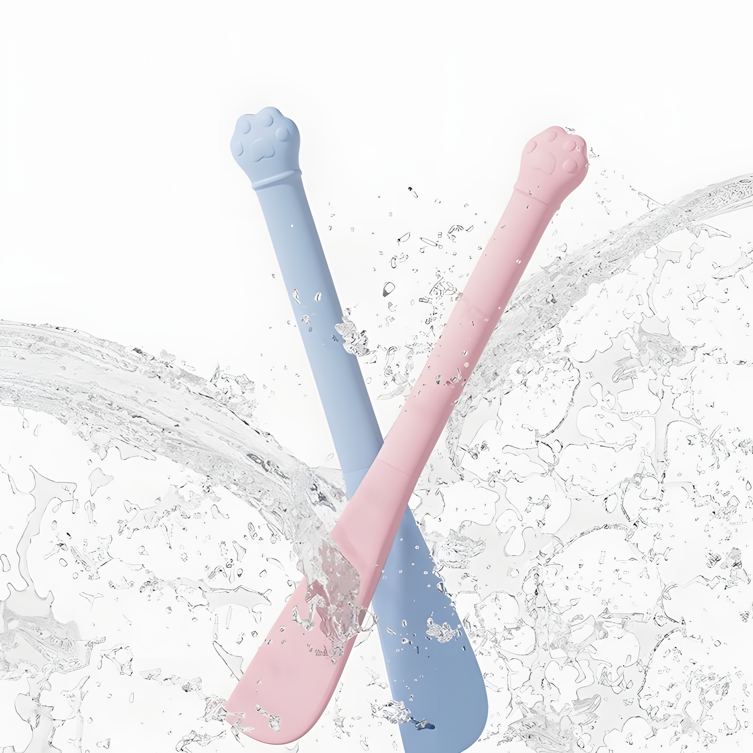 Blue and pink silicone cat food spatulas being splashed with water, demonstrating their water-resistant material and effortless cleaning process.