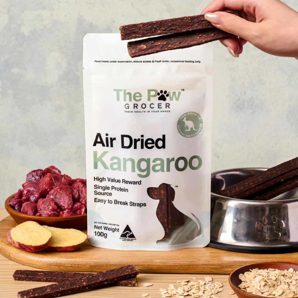A hand snapping The Paw Grocer air-dried kangaroo straps into smaller pieces. Soft and easy-to-break texture ideal for repetitive dog training and recall.
