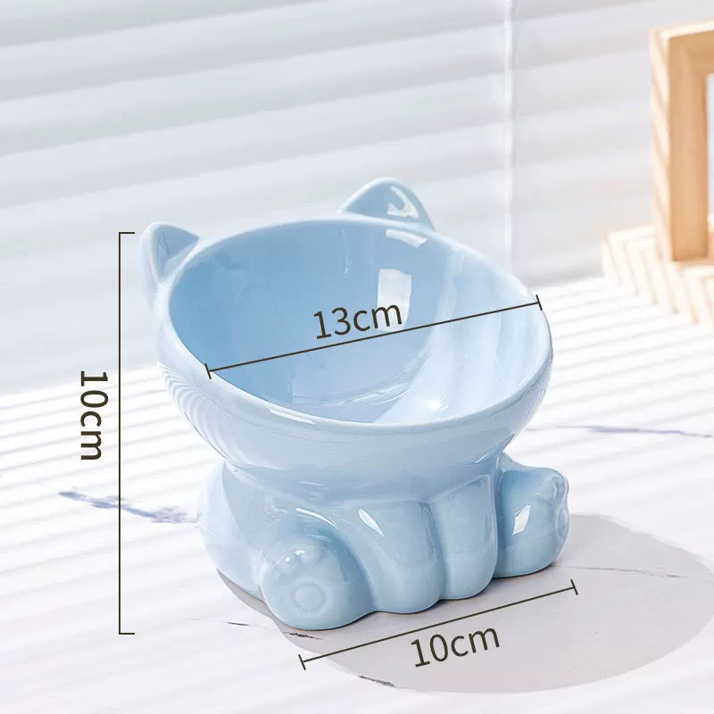 A light blue elevated ceramic cat bowl showing its dimensions, featuring a 13cm wide opening to prevent whisker fatigue and a 10cm height for comfortable eating.