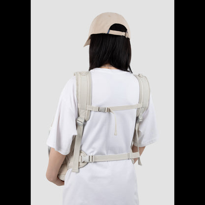 Back view of a pet owner wearing the ergonomic pet front carrier, showcasing the narrow-shoulder friendly straps and secure cross-body buckle for optimal lumbar support.