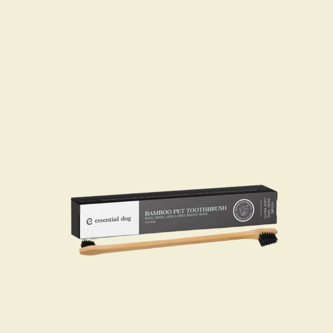 The Essential Dog double-sided bamboo pet toothbrush displayed in front of its sleek black packaging box, highlighting the ultra-soft dual small and large brush heads.