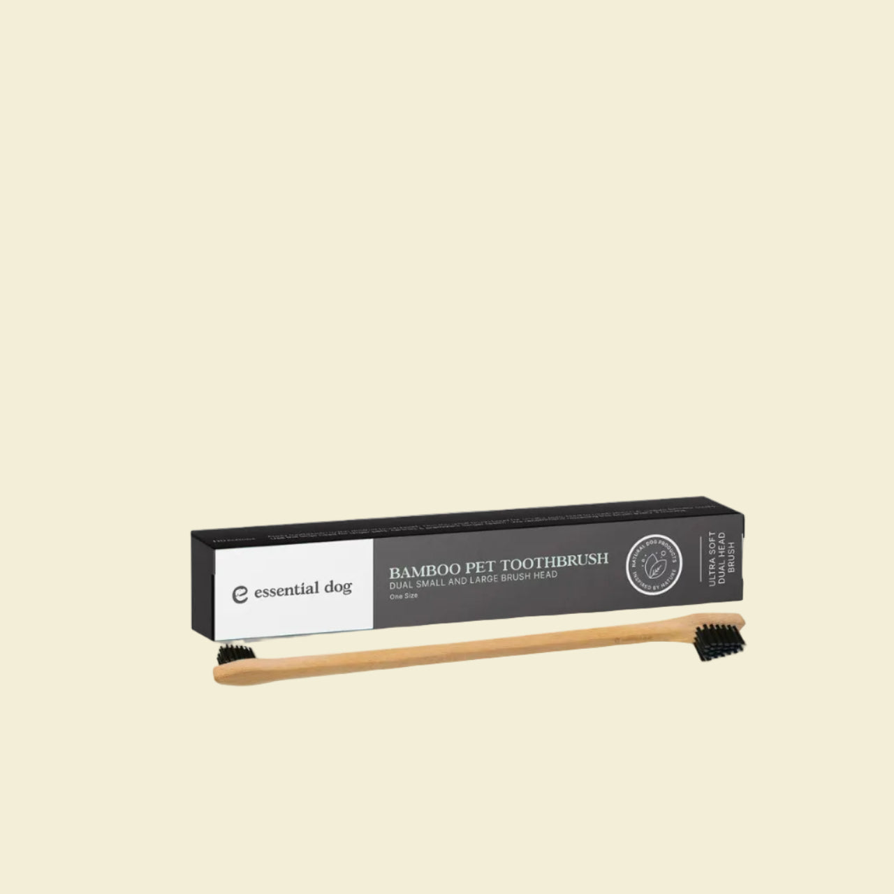 The Essential Dog double-sided bamboo pet toothbrush displayed in front of its sleek black packaging box, highlighting the ultra-soft dual small and large brush heads.