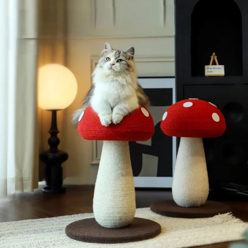 A fluffy cat relaxing comfortably on the bold red cap of the mushroom cat scratching post, demonstrating its wobble-free stability and storybook aesthetic.